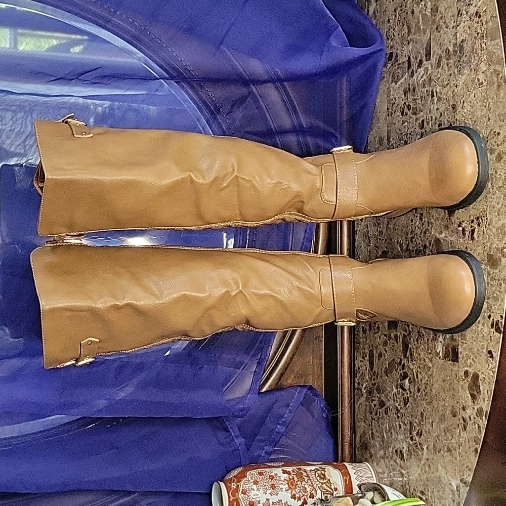 Tan women's knee high leather riding boots.
